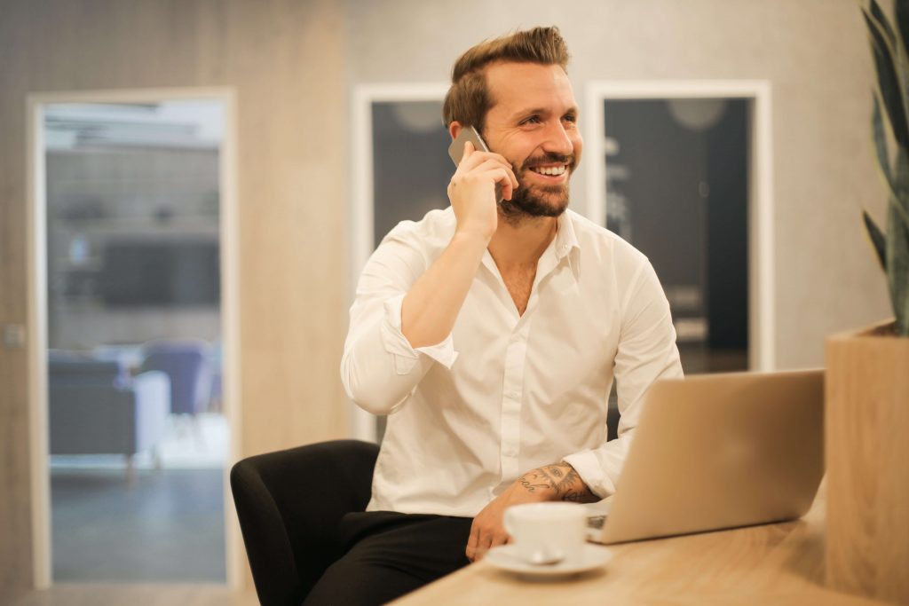 Man on the phone doing shopify consulting as a way to make money with shopify