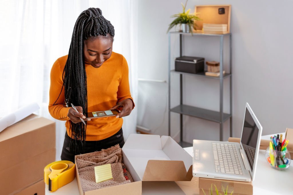 woman preparing package to ship after sale online, illustrating best things to sell on shopify
